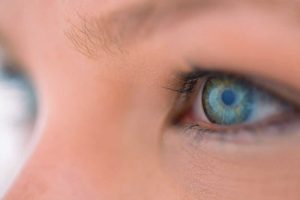 Girl with cataract looking across a camera